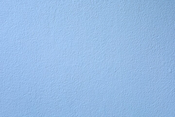 Soft light blue painted wall texture background. Subtle rough surface with copy space. Perfect...