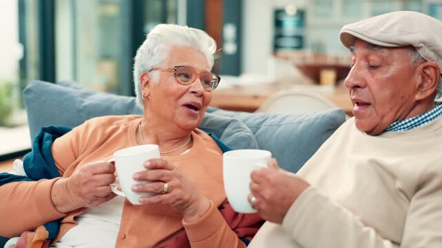 Cheers, coffee and senior couple on sofa in home with bonding, love and marriage together. Happy, toast and elderly man with woman drinking warm beverage in living room on weekend at apartment.
