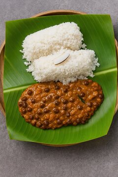 Kadala Curry with Kerala Puttu served on rustic banana leaf tray in bright natural light