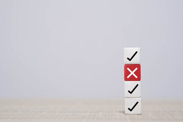Stacked cubes with checkmarks and a red X symbolizing decision-making, quality control, approval process, error detection, and evaluation concepts in a clean minimalist business setting.