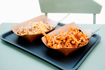 two pasta servings on an outdoor table