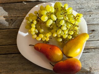 green ripe grapes on a plate