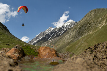 Tourists paragliding 3 pm 6 june 2025 at Leh Ladakh with view of Himalayan mountain range.