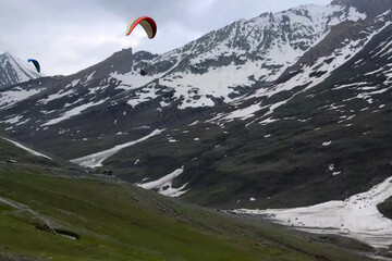 Tourists paragliding 3 pm 6 june 2025 at Leh Ladakh with view of Himalayan mountain range.