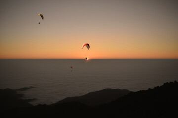 Paragliding over the clouds sunset view at Bir Billing Himachal Pradesh India. Clouds in the sky, Dhauladhar peaks view 5 pm 20 May 2025