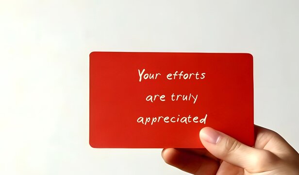 Hand holding card written YOUR EFFORTS ARE TRULY APPRECIATED -Employee Recognition or acknowledging rewarding employees for contributions effort and achievements to show they are valued