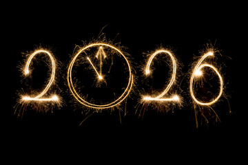 Happy New Year 2026. Burning sparkling text 2026 isolated on black background.