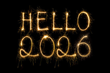 Happy New Year 2026. Burning sparkling text 2026 isolated on black background.