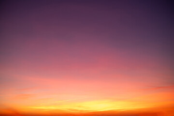Sunset or sunrise sky with a vibrant gradient of orange, gold, and soft blue. Clear atmosphere with wispy clouds. Peaceful, natural light background. hope, freedom, new day and inspirational Concepts