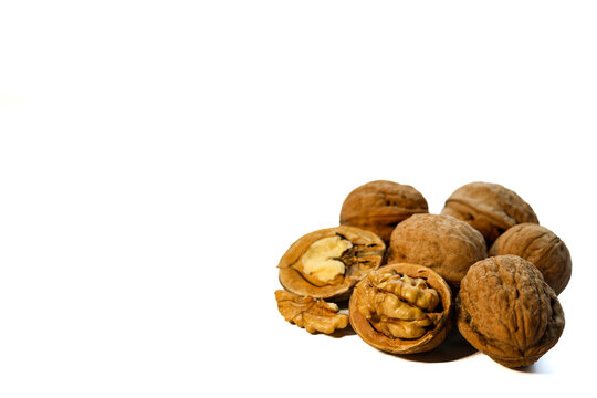 Whole and peeled brown walnuts on the white background - Powered by Adobe