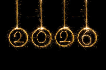 Happy New Year 2026. Burning sparkling text 2026 isolated on black background.