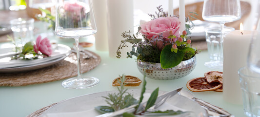 A festively set table for a wedding dinner. Tastefully decorated restaurant background with short depth of field.