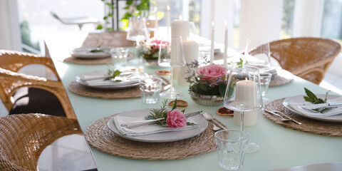 A festively set table for a wedding dinner. Tastefully decorated restaurant background with short depth of field.
