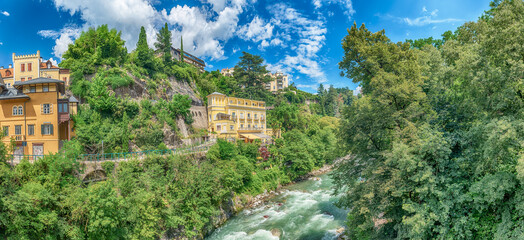 Passirio River flowing through Merano city center, South Tyrol, Italy