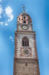 Clocktower of St. Nicholas Church, iconic landmark in Merano, Italy