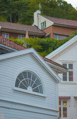 Traditional wooden houses on hillside at dusk.