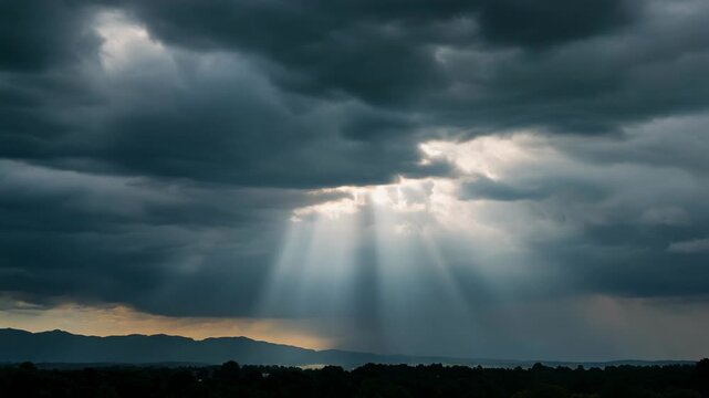 Dramatic Sky with God Rays Shining Through the Clouds Over Mountains.