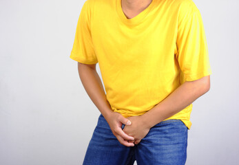Man holding his groin, Prostatitis Concept, Penile Cancer, Testicular Tumor, young man holding his groin, genitourinary problems, prostate cancer. Man Holding his penis, holding back urine uncontrolla