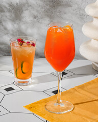 Bright orange and light orange cold drinks
Sunlight on a table and walls