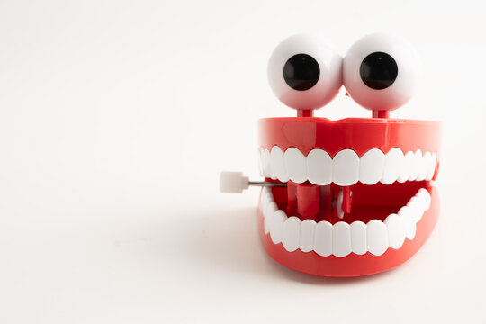 Funny red teeth with eye toy denture model for dental health care.