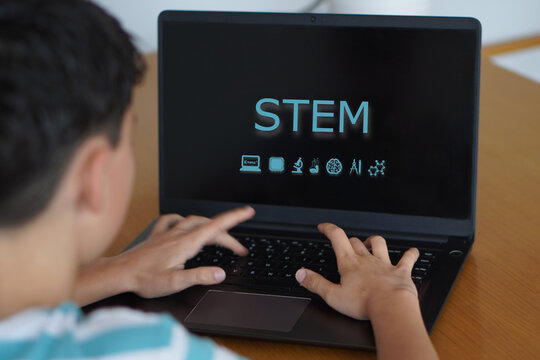 stem. children, education, and technology. preteen boy with the word on his laptop screen