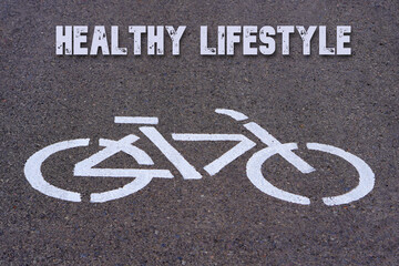 Healthy lifestyle. Words written on the asphalt above a bike lane icon.