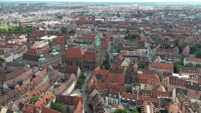 Aerial view of St. Lorenz Church towers over the red-roofed buildings, a symphony of urban textures in the historic heart of the city, Nuremberg, Bavaria, Germany.