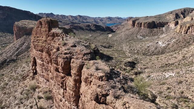Aerial view of rugged mountains and desert landscape displaying earthy tones and textures, creating a natural and wild scene, Apache Junction, Arizona, United States.