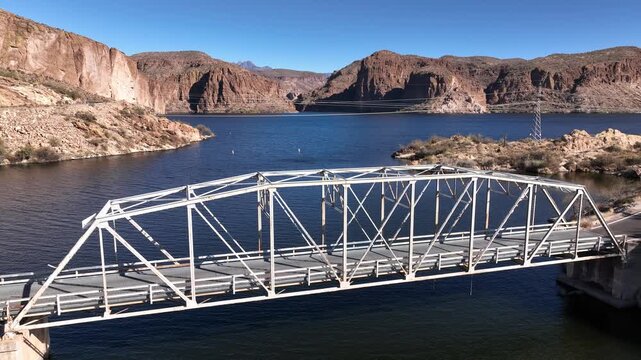 Aerial view of the bridge spanning the water, connecting the rugged landscape under a clear sky, a scenic view, Apache Junction, Arizona, United States.