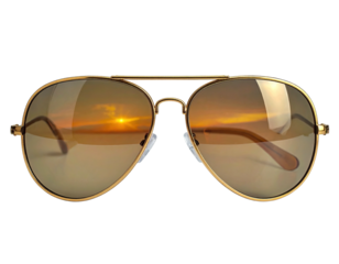 Close-up of stylish gold-framed aviator sunglasses with sunset reflections on the lenses