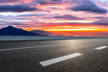 Fototapeta premium Empty asphalt highway road and mountain range with beautiful sky clouds natural landscape at sunrise