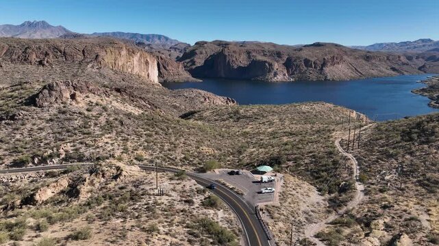 Aerial view of Canyon Lake nestled among rugged mountains, showcasing the contrast between the deep blue water and the arid landscape, Apache Junction, Arizona, United States.