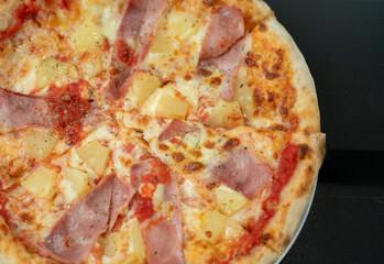 Hawaiian Pizza , pineapple , ham and cheese on wooden table