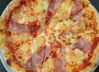 Hawaiian Pizza , pineapple , ham and cheese on wooden table