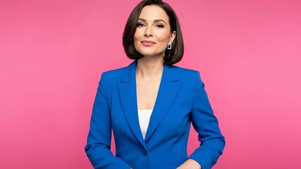 A confident woman in a blue suit against a vibrant pink background.