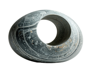 A close-up of a stone, torus-shaped sculpture with striped, gray and white patterns