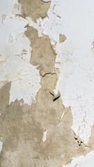 old wall with peeling white paint. background