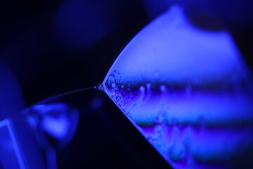 Purple liquid glowing flat film, colourful macro abstraction, interference pattern, glowing elements