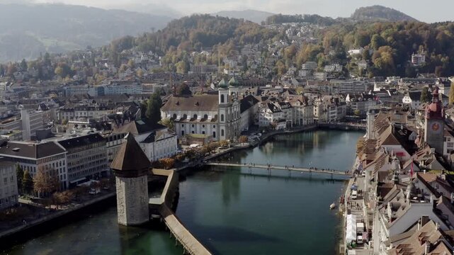 Aerial view of the iconic Chapel Bridge and the serene Reuss River winding through the heart of the city, a blend of history and nature, lucerne, lucerne, Switzerland.