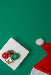 gift box with Christmas ball on a green background