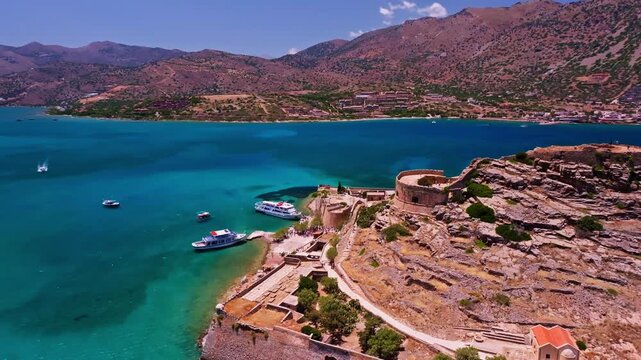 Aerial view of the Spinalonga island, showcasing the turquoise waters surrounding its formidable stone walls and historic ruins, Elounda, Lasithi, Greece.