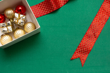 gift box with Christmas ball on a green background