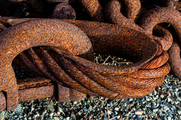 Close-up of heavily rusted metal cable and chain