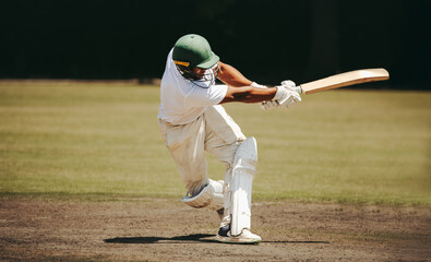 Professional cricketer batting on a sunny day on the cricket field