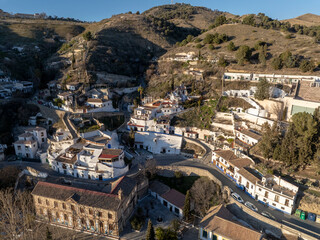 Sacromonte District in Granada, Spain. Aerial drone footage of the Traditional White Caved Dwellings at Sunset Light.