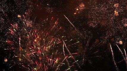 Multiple fireworks exploding with bright sparks in the dark night sky - Powered by Adobe