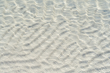 Baltic Sea beach scene showing coastal structures with blue water and soft sand in a peaceful natural area