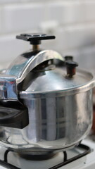 Stainless Steel Stovetop Pressure Cooker on Gas Stove in a Home Kitchen &ndash; Steam Valve, Cooking, Domestic Cookware	