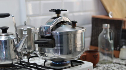 Stainless Steel Stovetop Pressure Cooker on Gas Stove in a Home Kitchen – Steam Valve, Cooking, Domestic Cookware	
