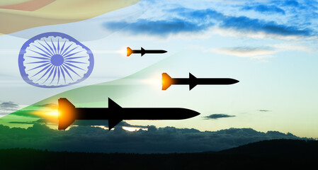 Fired missiles fly to the target. Missiles at the sky at sunset with Indian flag. Missile defense, a system of salvo fire.